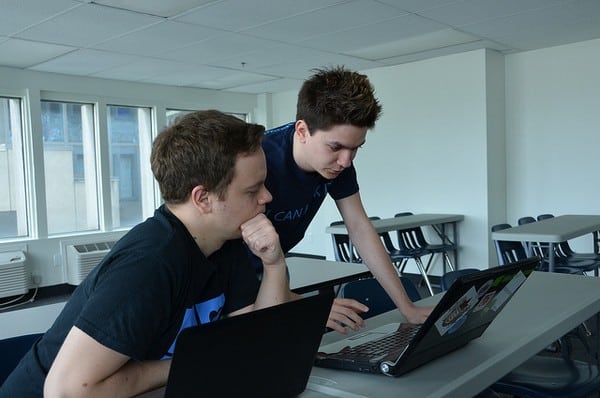 Sebastien (to the left), helping a developer at a hackathon