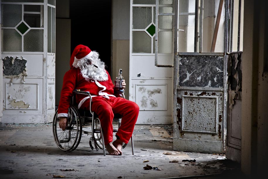 A drunk Santa in a wheelchair in a abandoned building