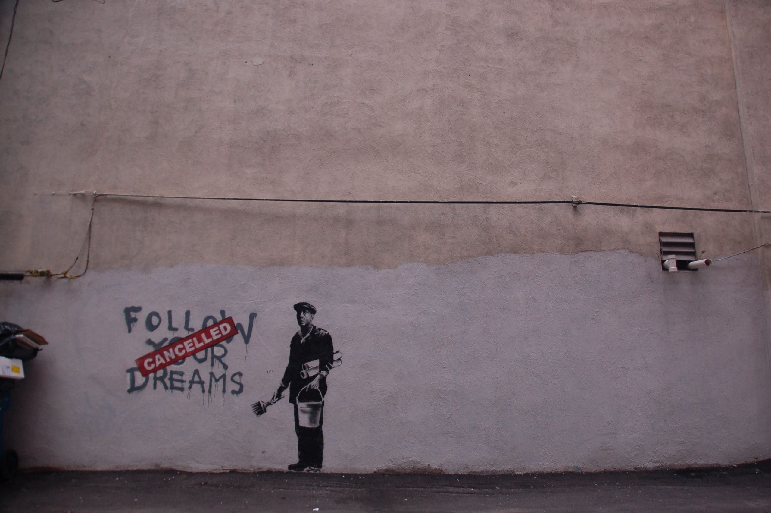 A grafiti Banksy style cancelling a follow your dream one