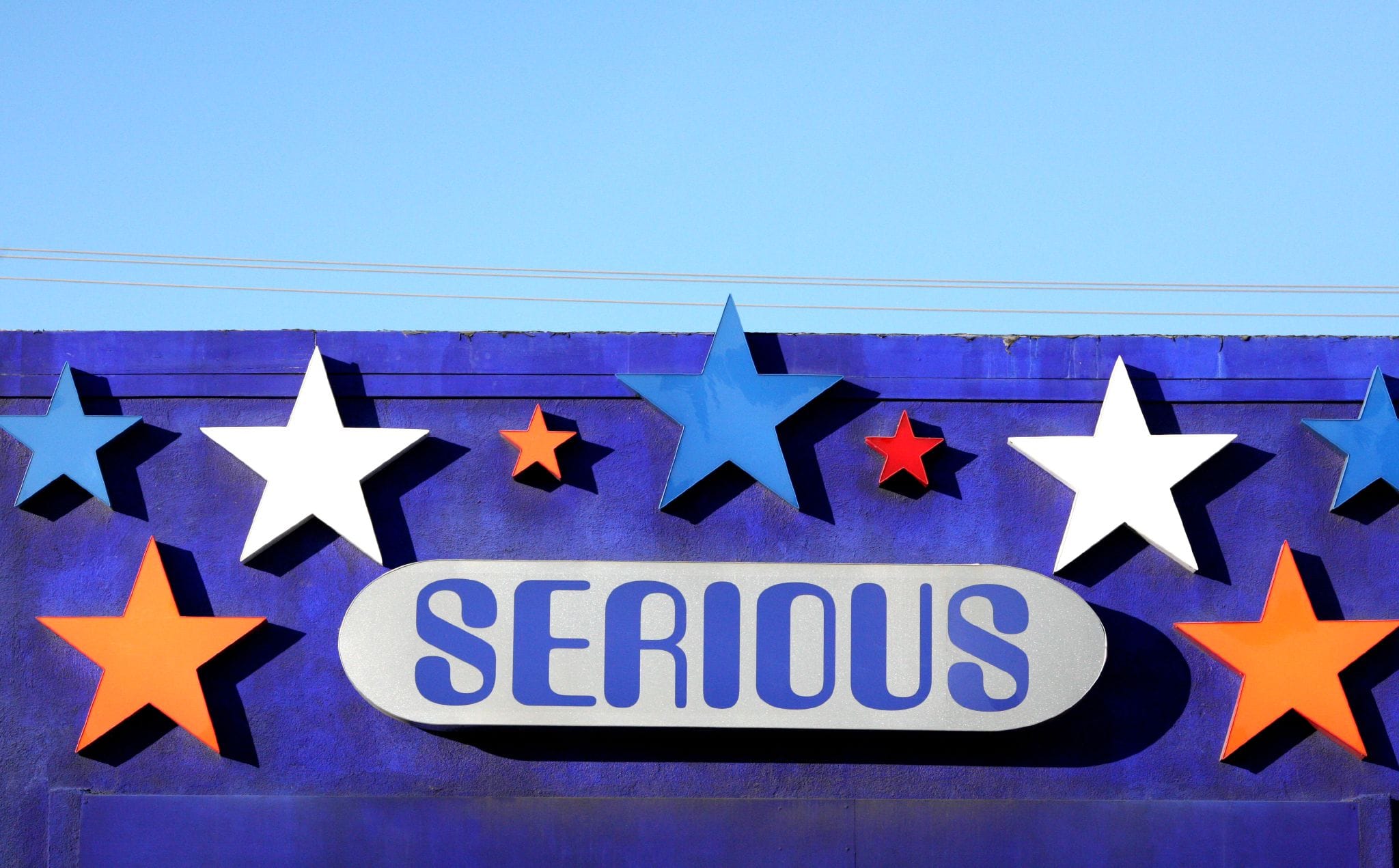 A building sign with stars and the word serious